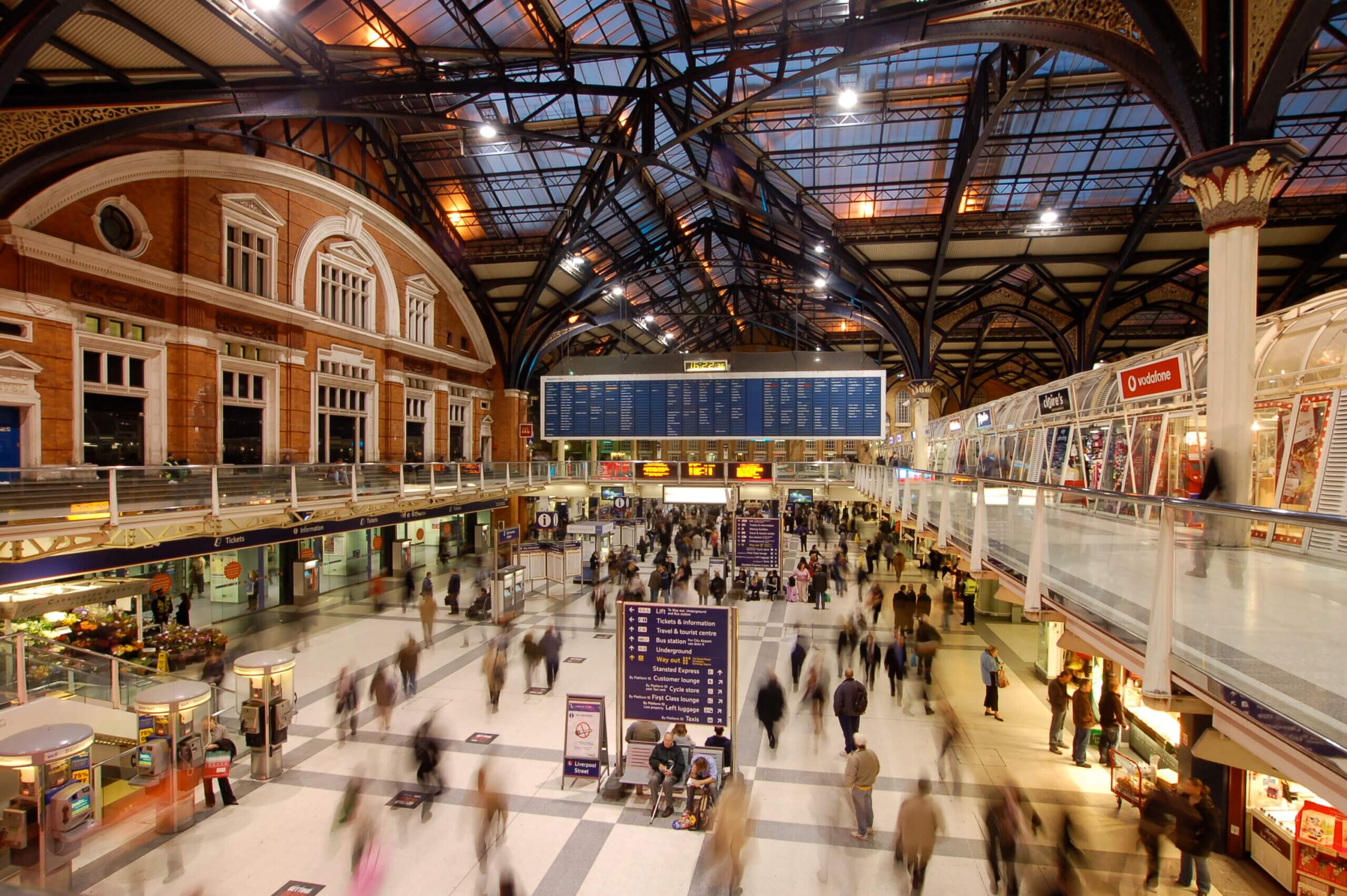 A high-angle view of one of the major London stations, with people passing by in a blur.