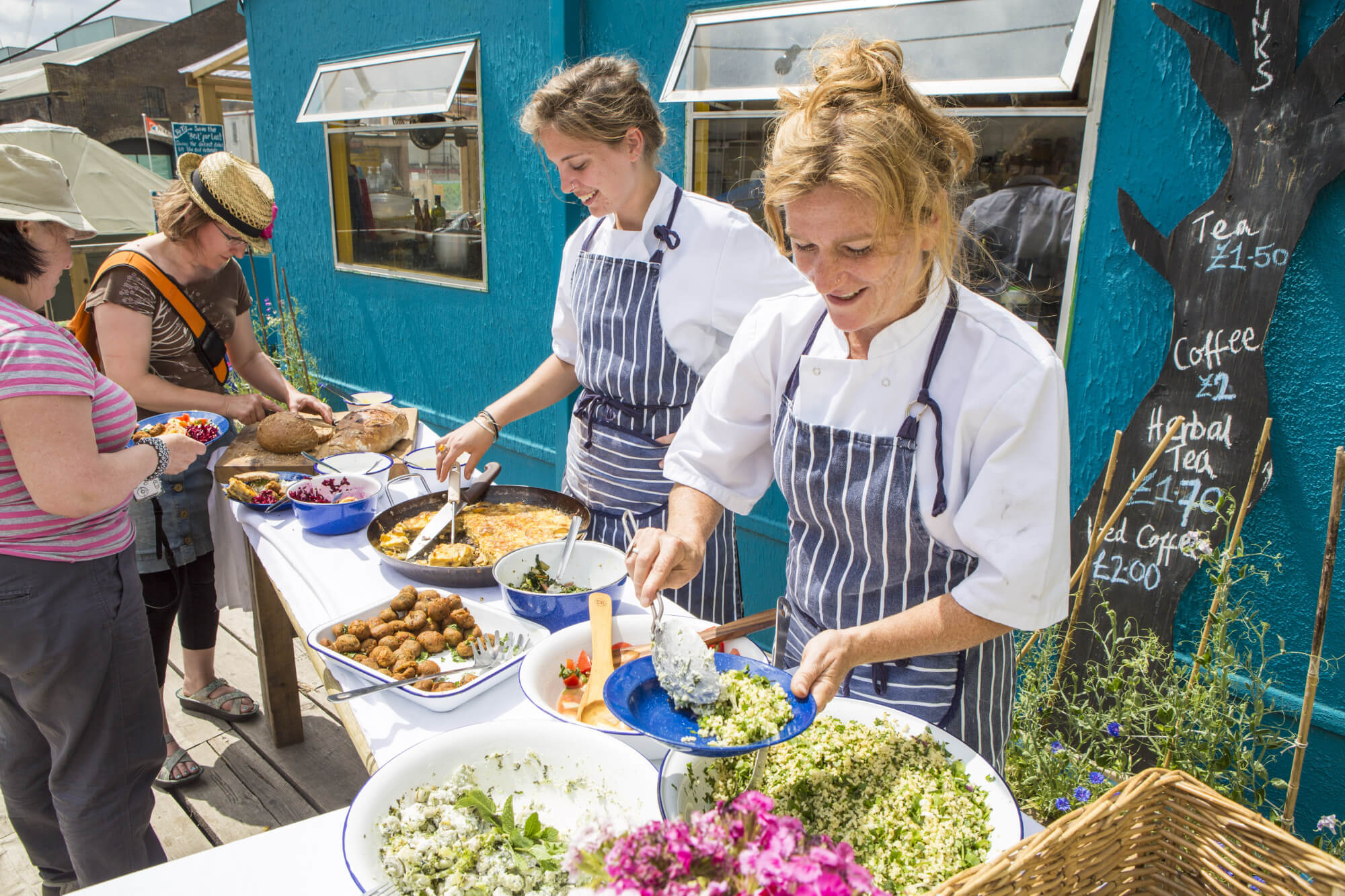 Skip Garden workers serving food, St Pancras